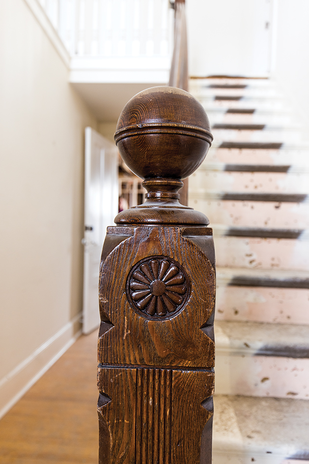Original carved wood handrail for the staircase.