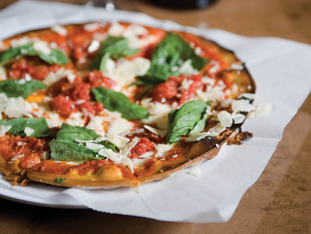A pie with fresh basil, tomatoes and cheese from Olive’s Fresh Pizza Bar.
