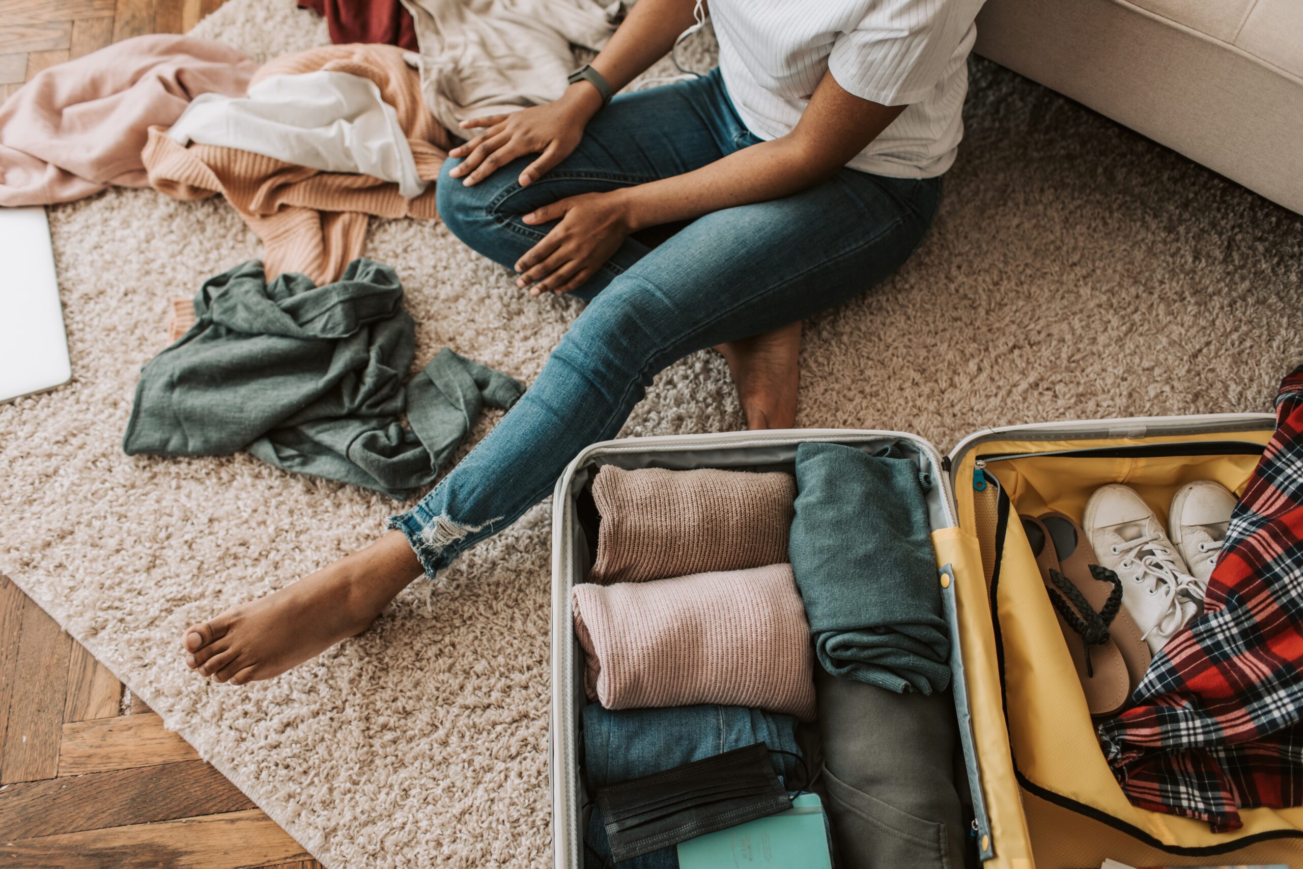 Woman packing a suitcase for vacation.