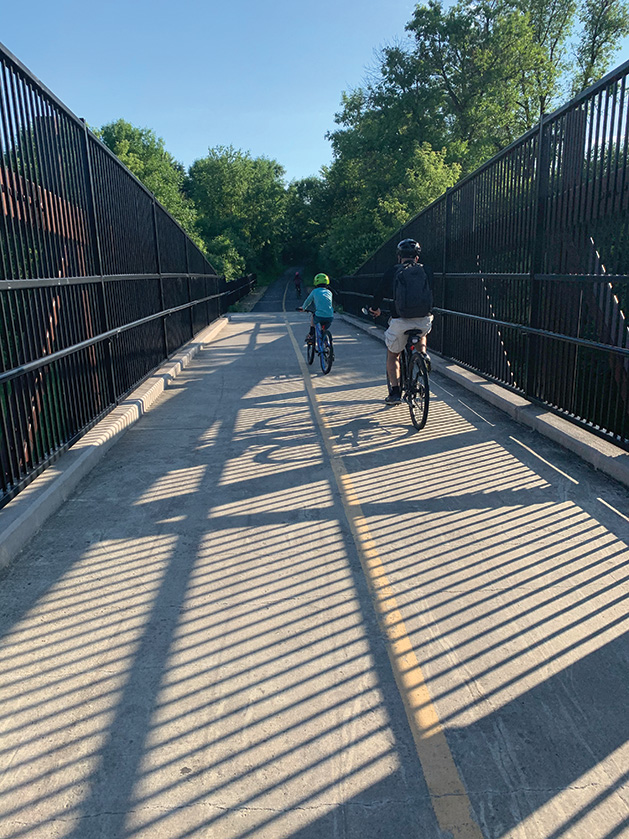 Family Biking Across Bridge