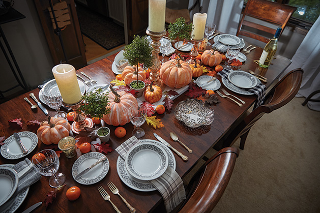 When decorating her Thanksgiving table, Phillips goes for a maximalist approach with fall decor and meaninful dishware. “Every piece has a story,” she says.