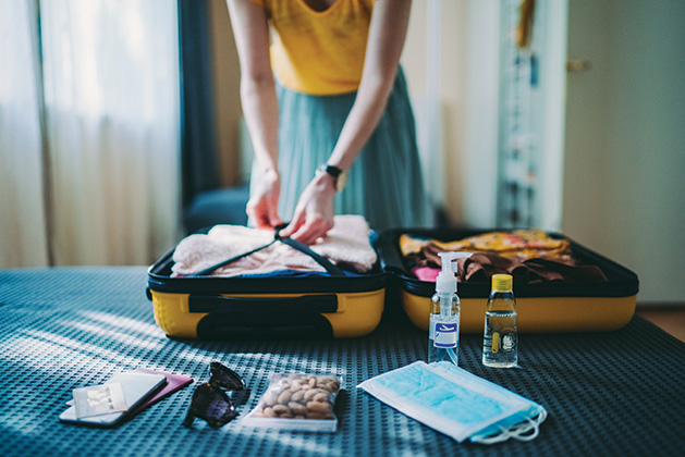 A woman packs her suitcase before a trip.
