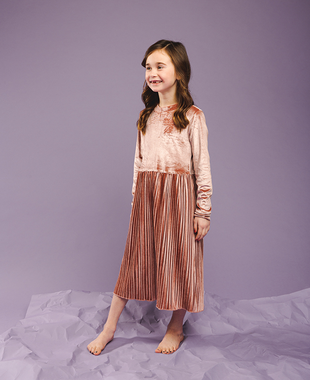A child models pink dress.