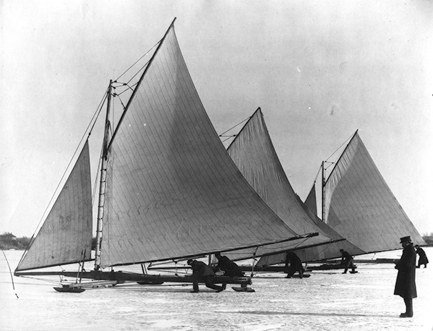 In this historical photo, a group of ice boats sail on Lake Minnetonka.