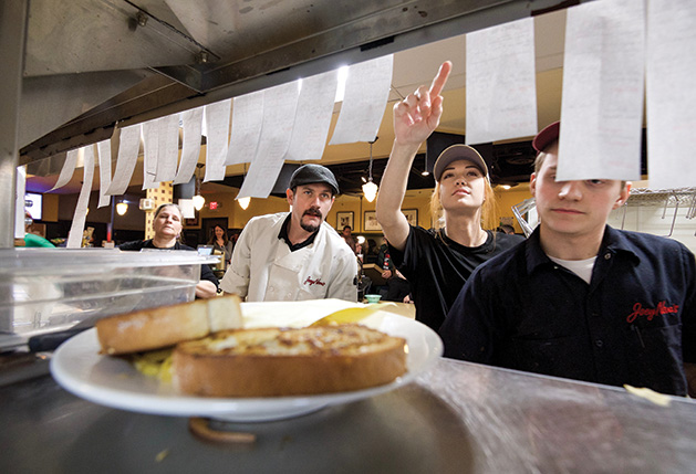 Joey Nova's Chef Gary Ezell and his employees review orders in the back kitchen.