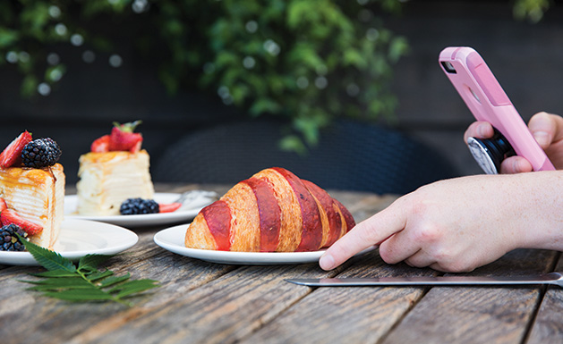 Taking a photo of a berry croissant.