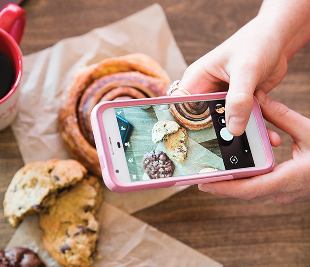 Taking pictures of pastries.