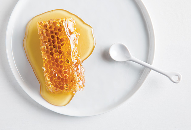 A honeycomb covered in honey from Ames Farm