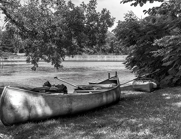 A black and white photo of a canoe set to launch on Gray's Bay on Lake Minnetonka.