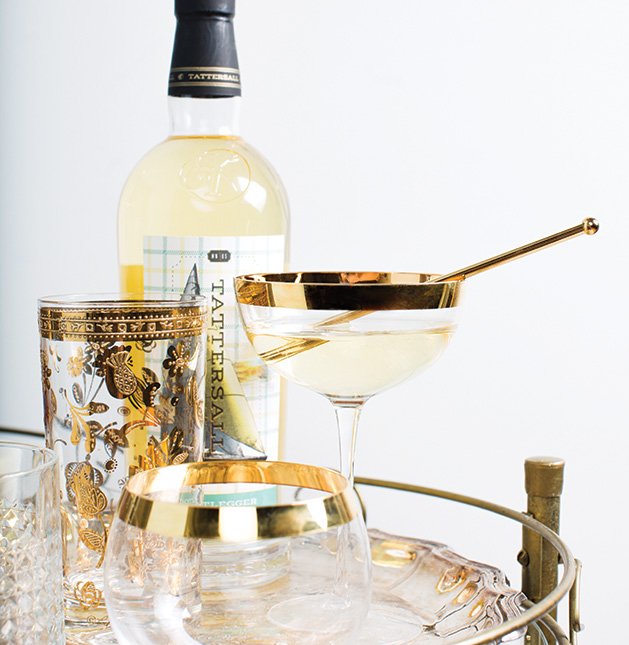 An aperitif sits on a bar cart with a bottle of liquor from Tattersall.