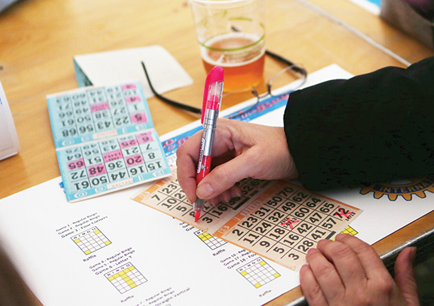 A person fills out their bingo card at the Bingo & Burgers by the Bay event.