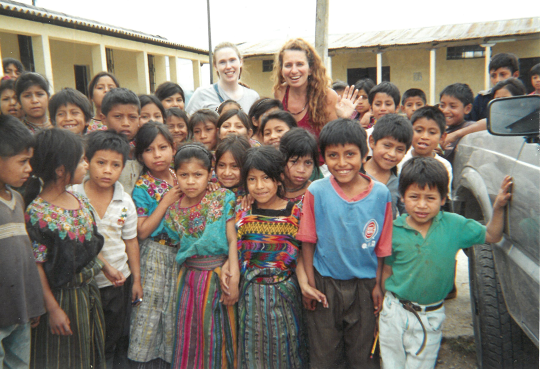 Over 20 years ago, children gather to receive dontated shoes, thanks to the efforts of Christine Valerius and donors.