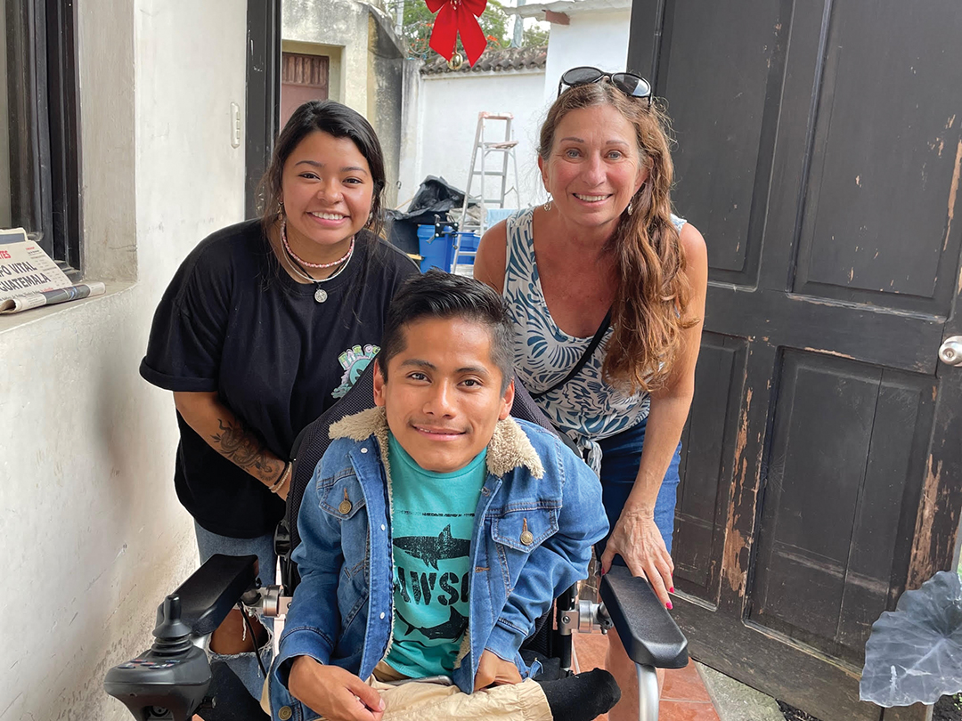 Maddy Fisk and her mother, Christine Valerius, visit with a young man, who they have spent time with during their visits to Guatemala. They bring him painting supplies to support his art.
