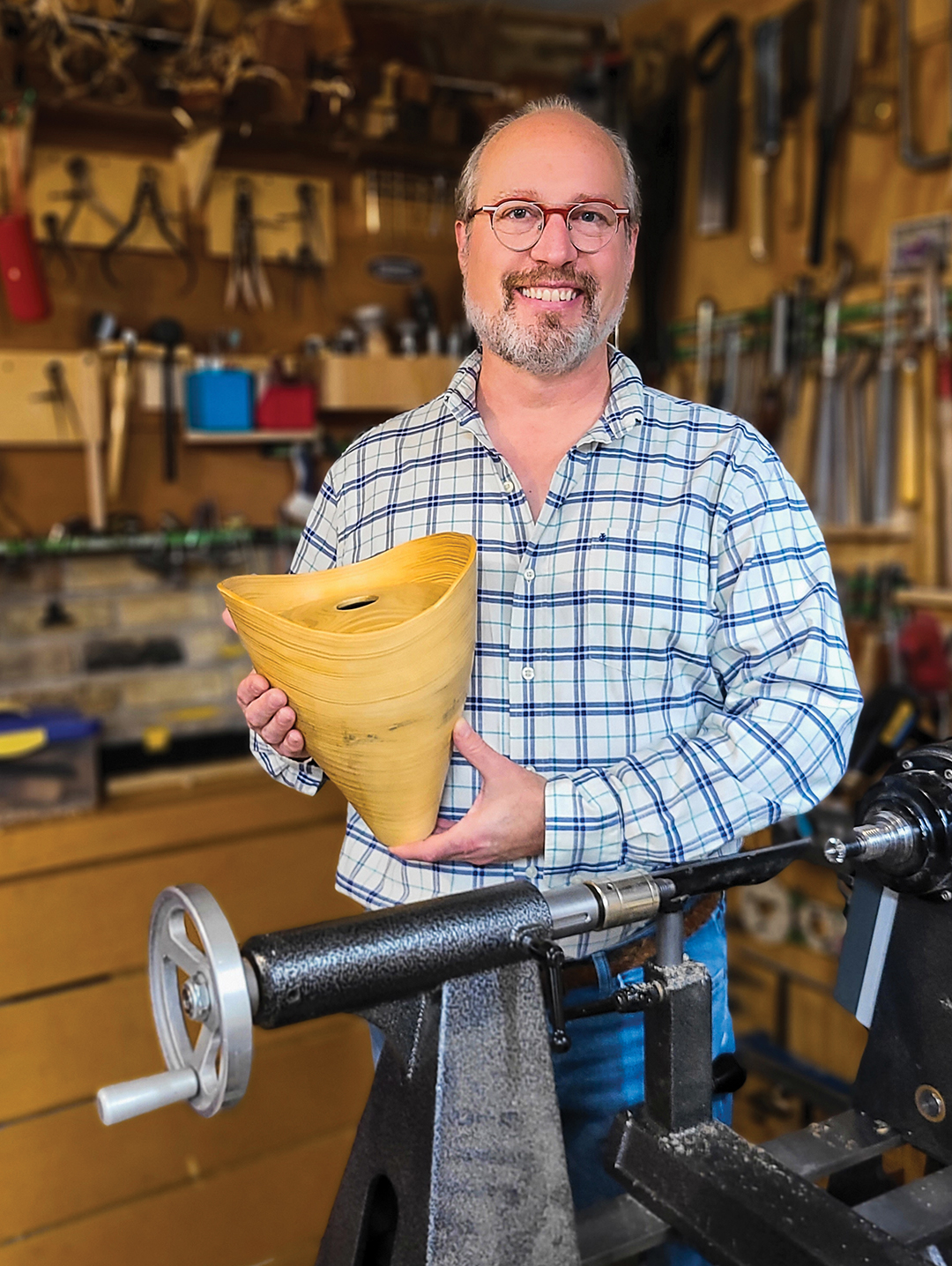 Bob in his shop, holding a natural edge Concolor Fir Vessel