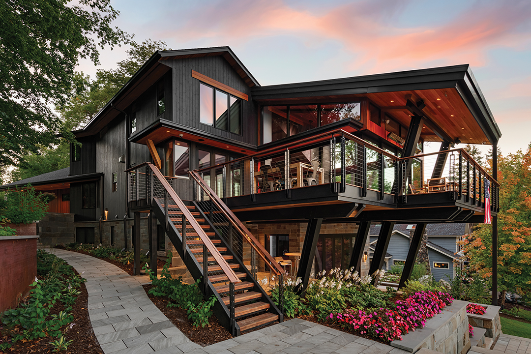 The home’s pièce de résistance is the deck, which flows seamlessly from the living room and makes visitors feel like they’re floating over Lake Minnetonka. A commercial-grade steel structure angles up from the ground, through the deck and meets the roof, creating the cantilevered expanse of the deck without a need for bulky posts—and maintaining those unobstructed lake views. Under the deck is a walkout patio that leads from the guest suite.