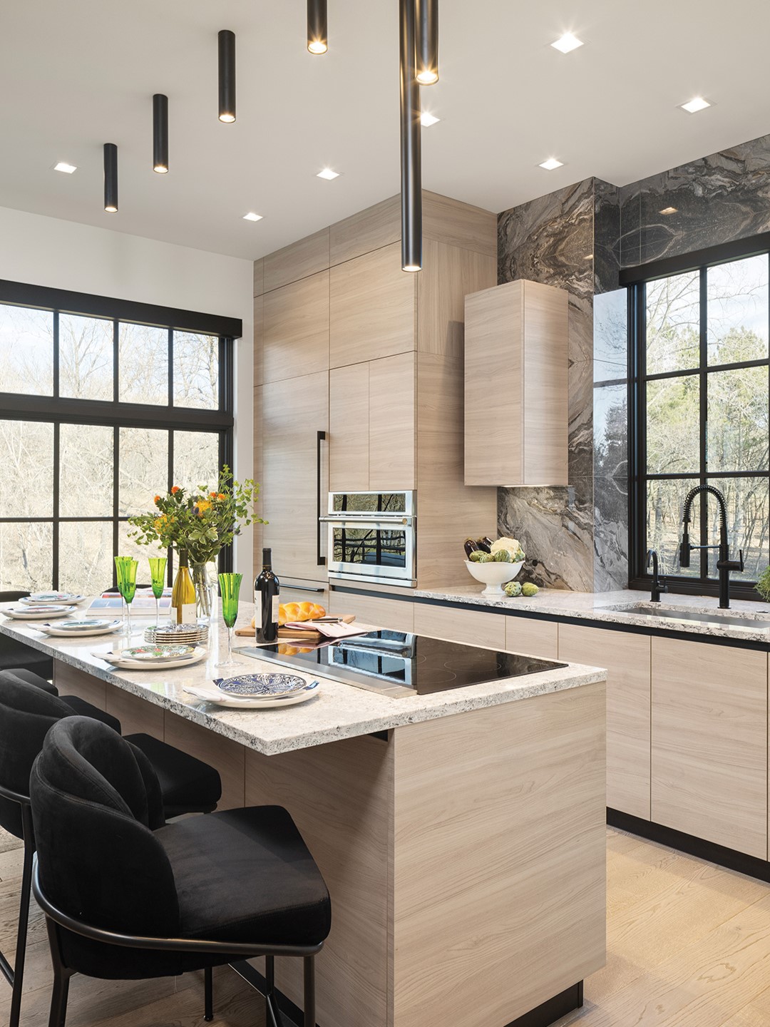 The homeowners’ goal for the guest house kitchen was to create a space that was relaxed and inviting. Sleek, clean lines are everywhere, from the flat-front cabinetry to the cylindrical light fixtures over the island. In keeping with the modern eat-in kitchen trend, the island offers seating to enjoy snacks, drinks and conversation while still leaving plenty of room for cooking. Payares says the Studio Brown Bag team worked with Scavolini, an Italian kitchen provider that offers products and materials with a high-end, European aesthetic.