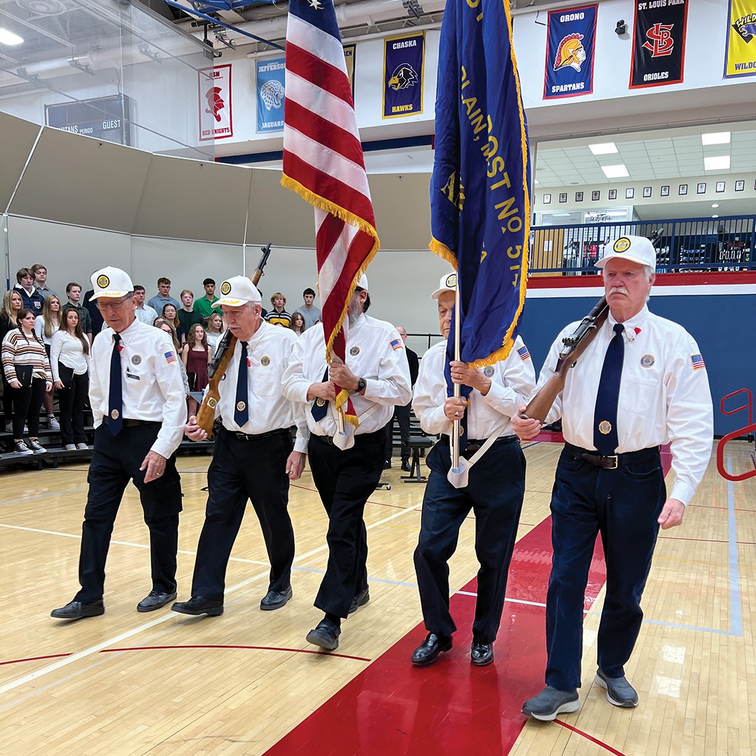 Volunteers assist with a Veteran's Day Service. 