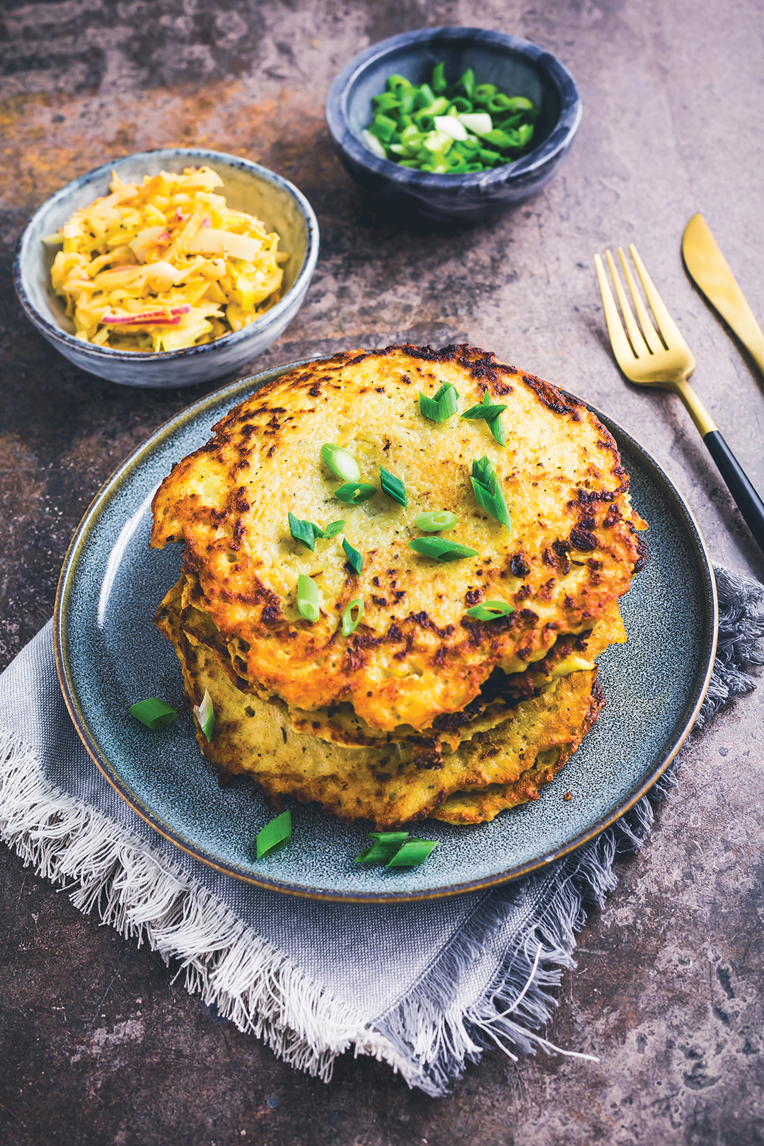 Homemade hash browns or potato pancake with cabbage salad and green onions