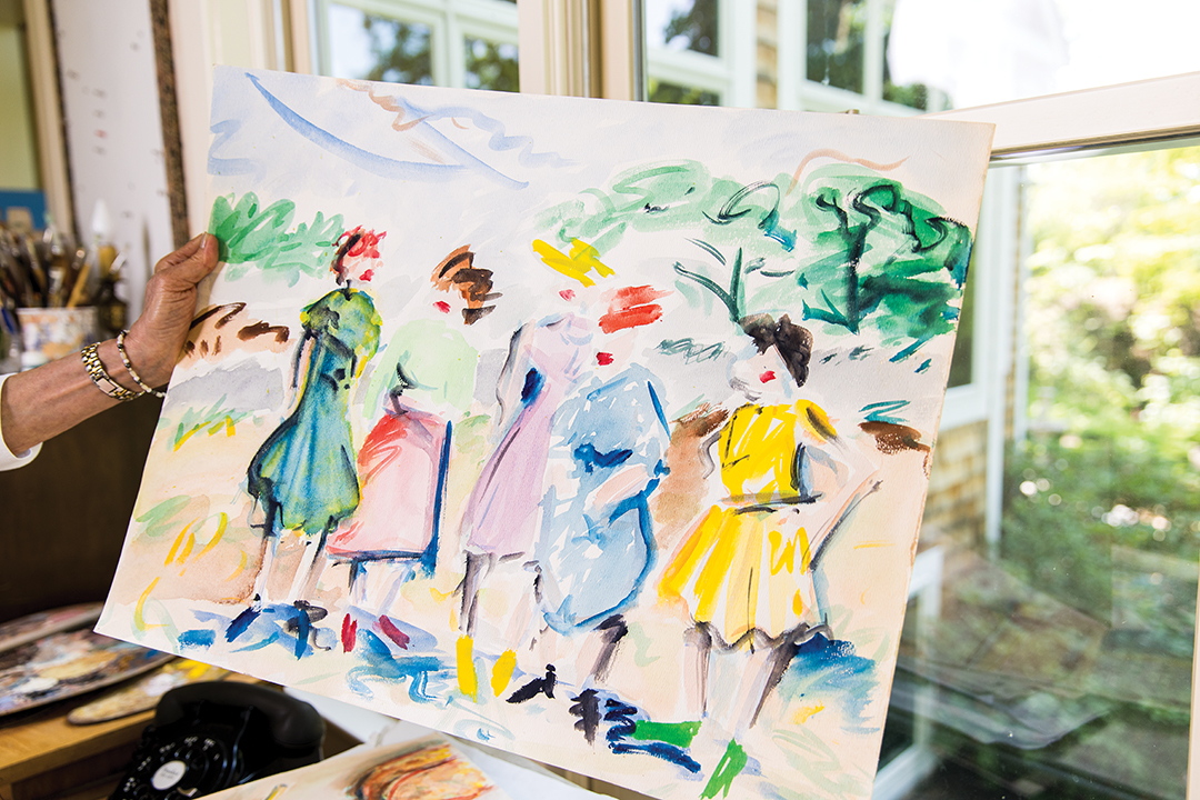 Diane Foote holds one of Christopher Foote’s paintings.