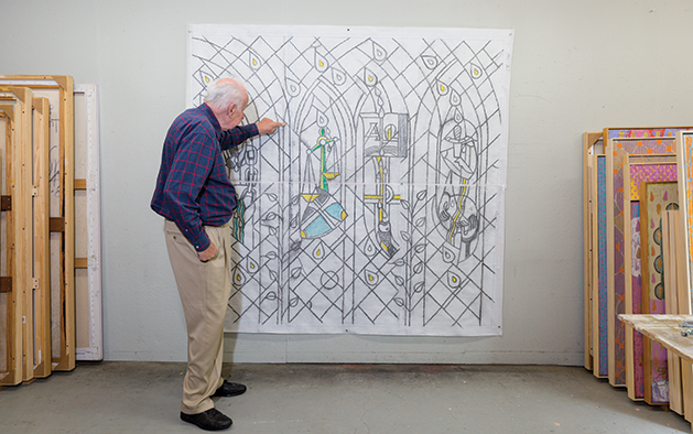 Dieterich Spahn points out details on a full size sketch for a stained glass window.