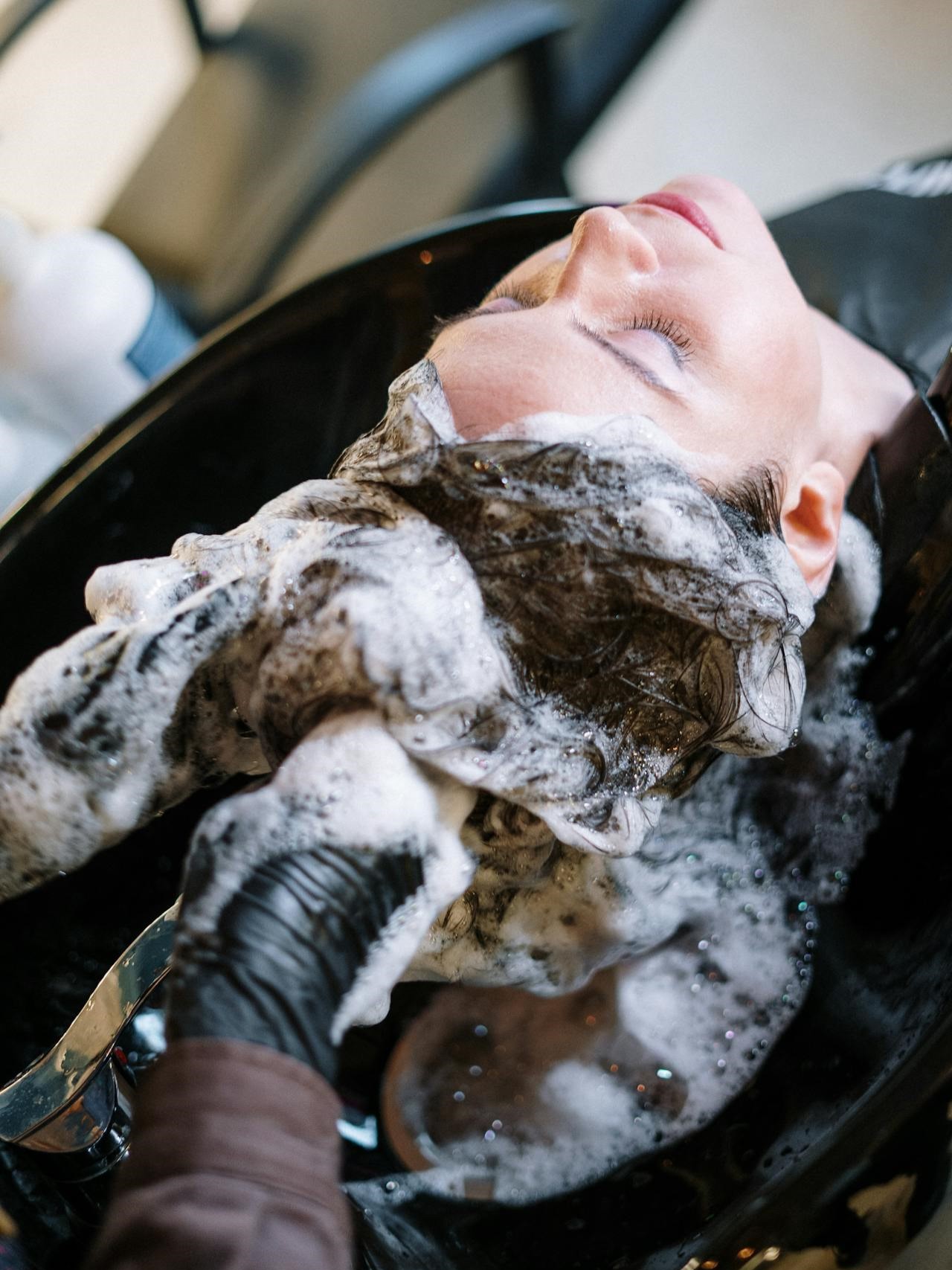 Woman getting her hair washed at a salon.
