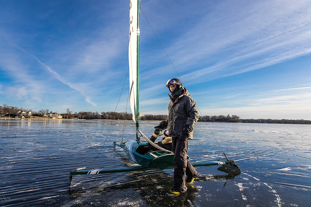 Only the winter-bare shoreline separates the blue hues of the sky above and Lake Minnetonka below as riders prepare for an icy turn across the frozen playing field.