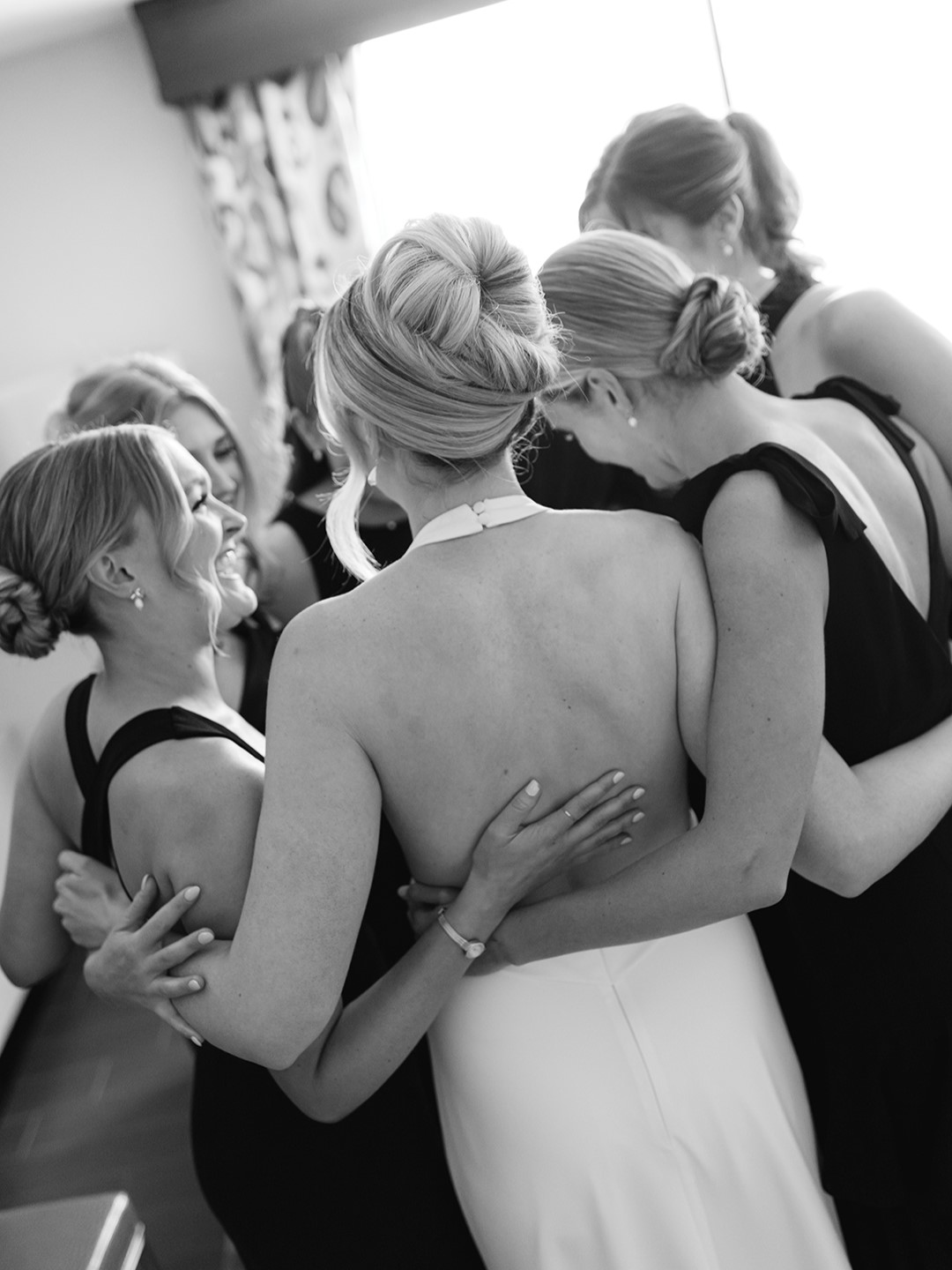 Bridesmaids were styled in long, black dresses of their choosing, and the bride gifted them with bow and pearl earrings, dovetailing with the (British brand) Jo Malone theme. In classic men’s fashion, the groom and groomsmen donned black tuxedos with black bow ties. The bride presented the groom, groomsmen, fathers of the couple, grandfather of the bride and the officiant with custom black, suede kippots with their initials embroidered in white.