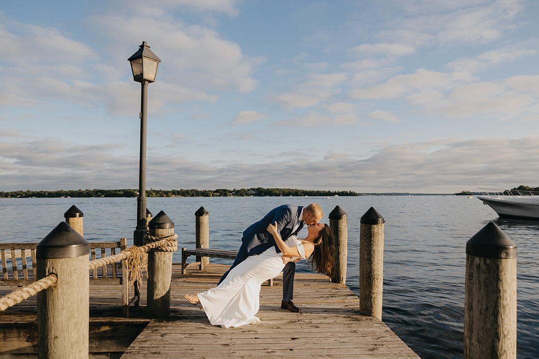 Wedding couple kissing with Lake Minnetonka in the background