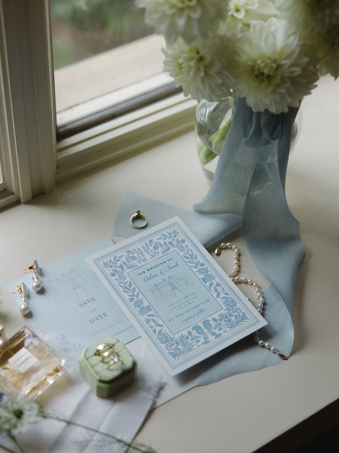 Wedding details with invitation and jewelry