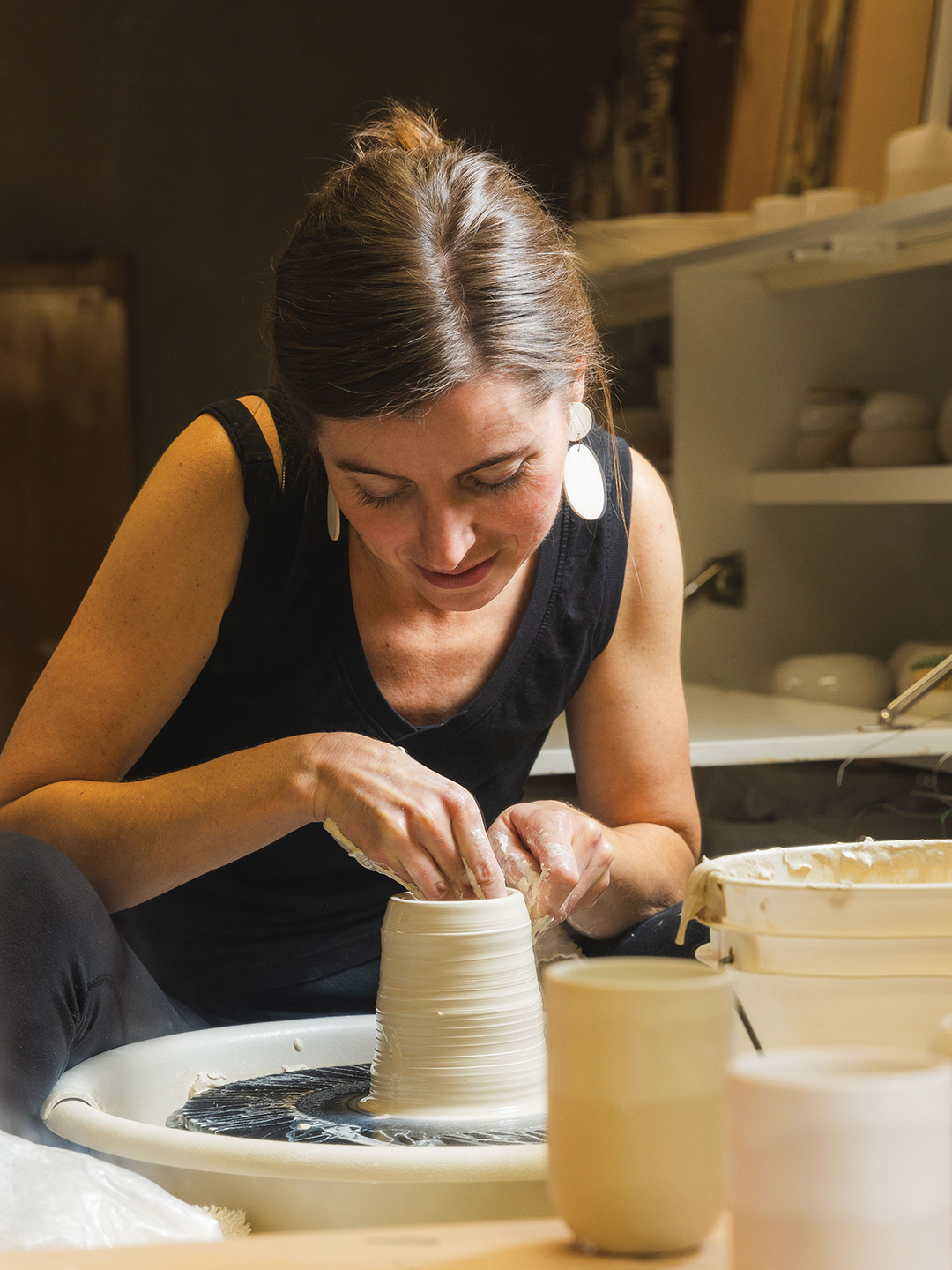 Danielle Uttecht using a pottery wheel