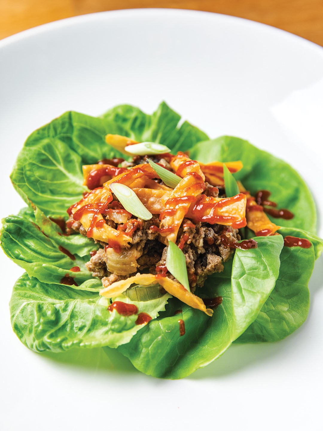 Warm Asian Butter Lettuce Salad with wonton strips is crispy and fresh.
