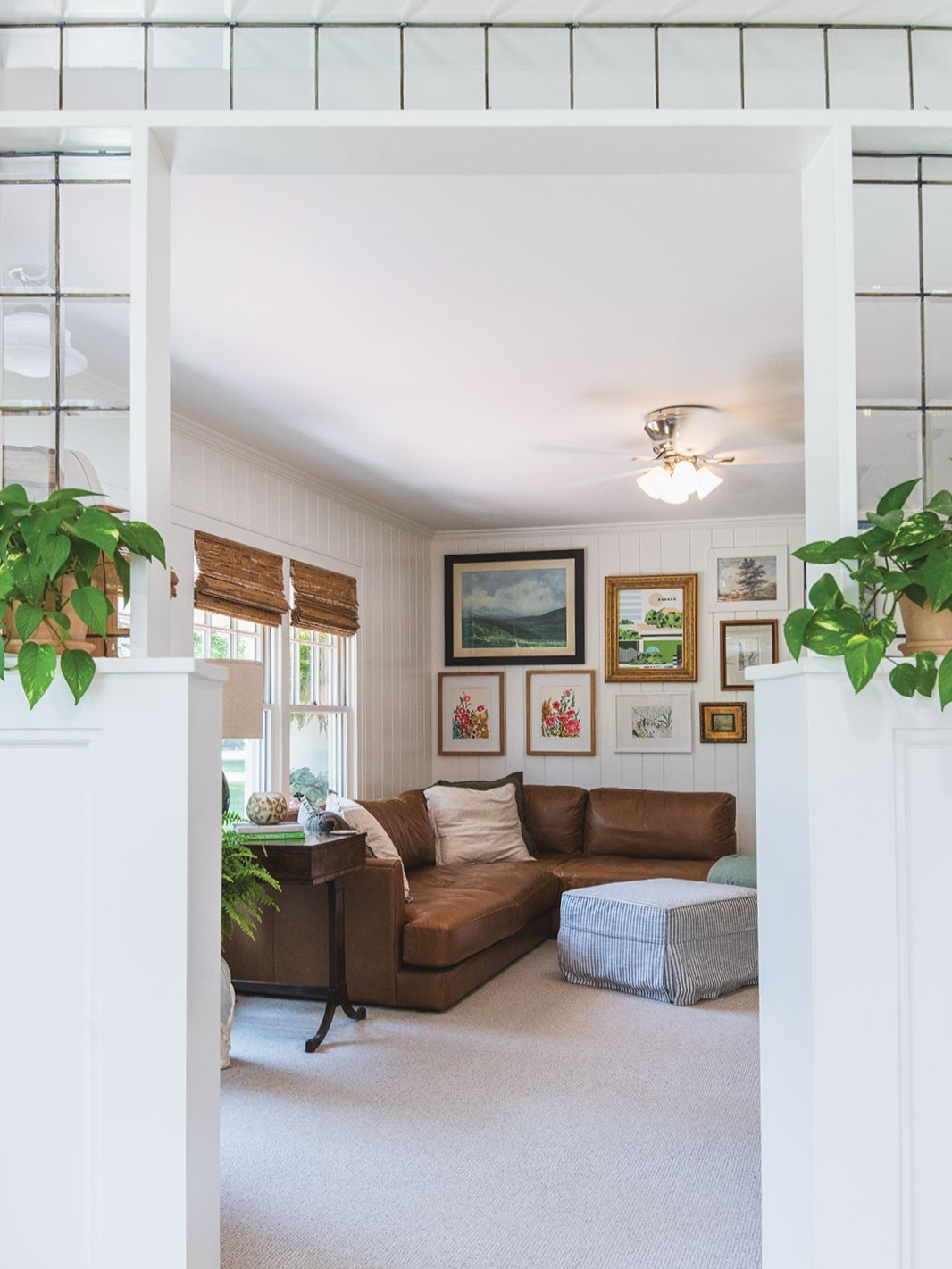 “The design inspiration came from artist Briana Auel’s piece [Concrete Jungle//Glass Ceiling]—its modern lines, vintage gold frames and palette of greens, pinks and blues set the tone for the entire room,” Andrea Soule says. “To layer in fun, I painted the fireplace in Breakfast Room by Farrow & Ball, displayed art we’ve collected over the years and incorporated antique pieces inherited from Chase’s [Hull] grandmother [Anne Hull].” Her father, Charles Soule, created the stained-glass entrance to the room, partnering with Down Home Stained Glass in Anoka.