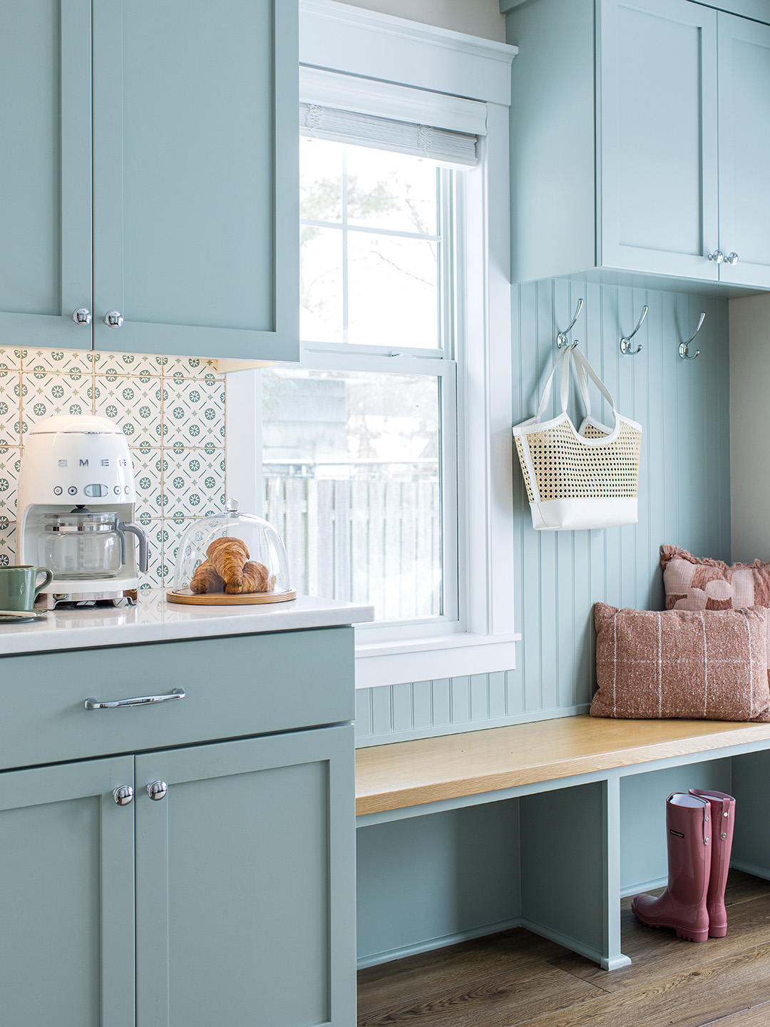 “We put in custom cabinetry, really nice quartz countertops and modern appliances that look old school,” Kate Kadlec says of the kitchen. What was once an eat-in nook is now a functional mudroom with custom lockers and a drop-zone counter.