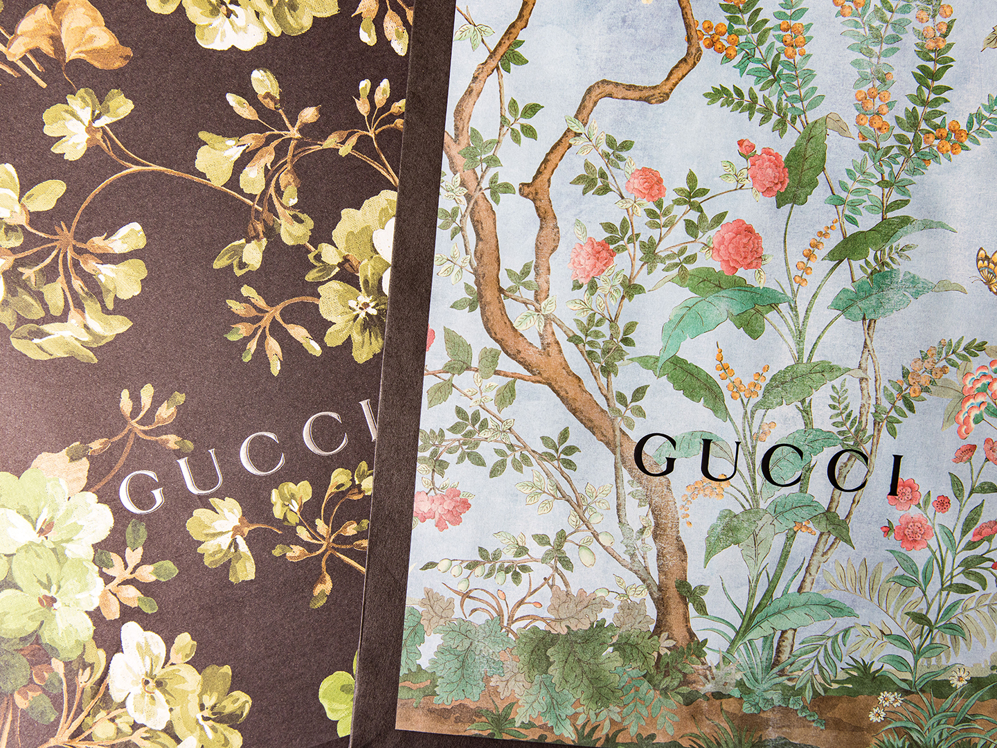 Two floral Gucci shopping bags
