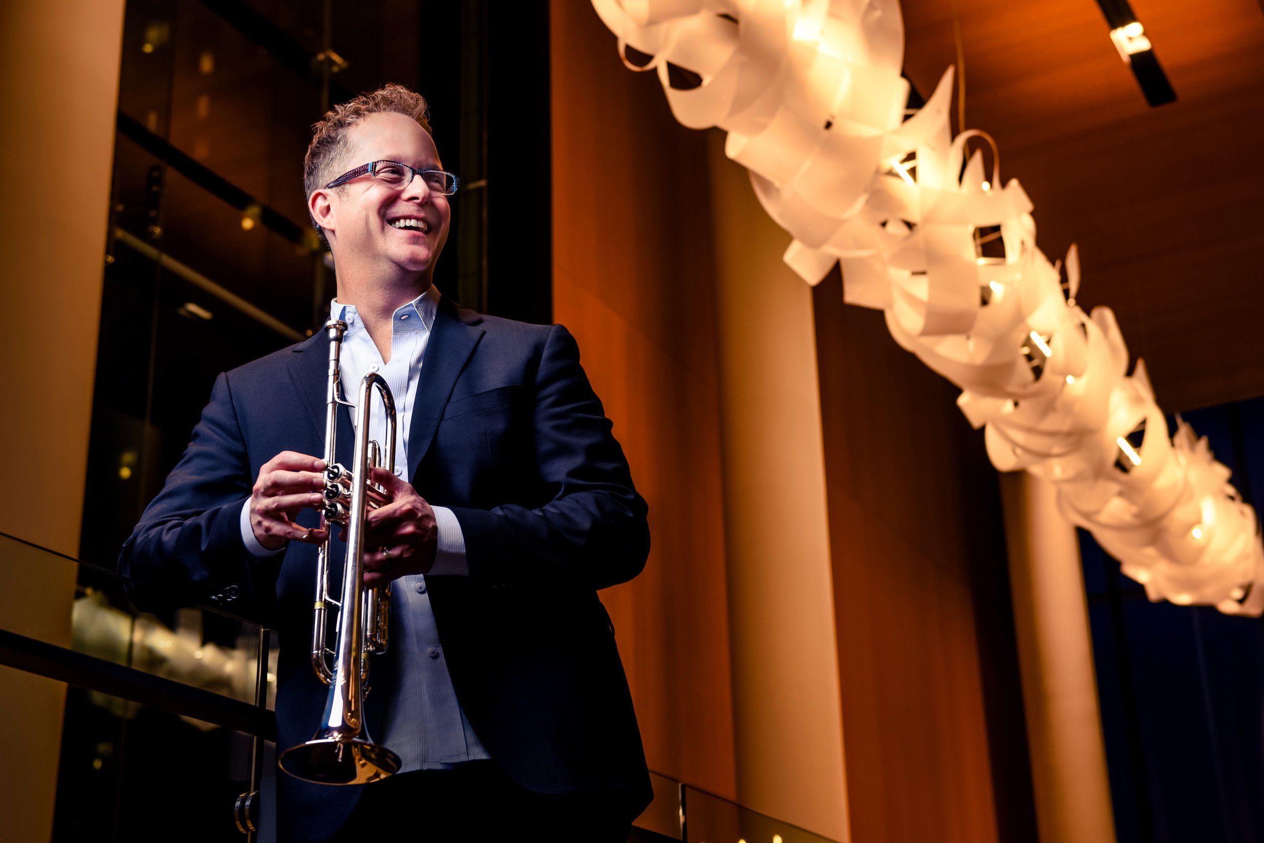 Charles Lazarus holding a trumpet