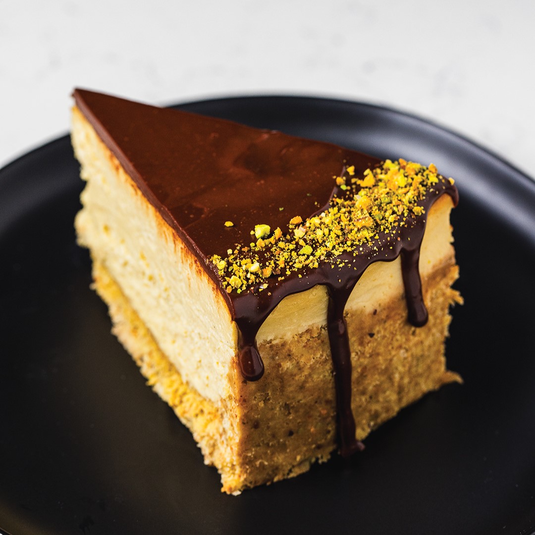 Slice of Dubai Chocolate Cheesecake on black plate