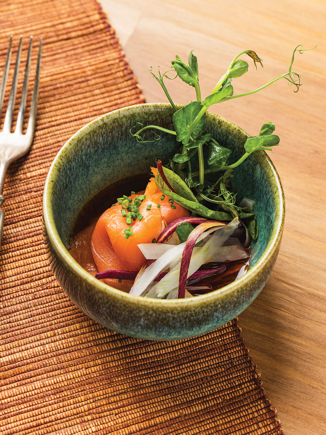 Salmon Crudo with pea shoots, strawberry consommé and radish brings taste, textural and visual interest to the table. 