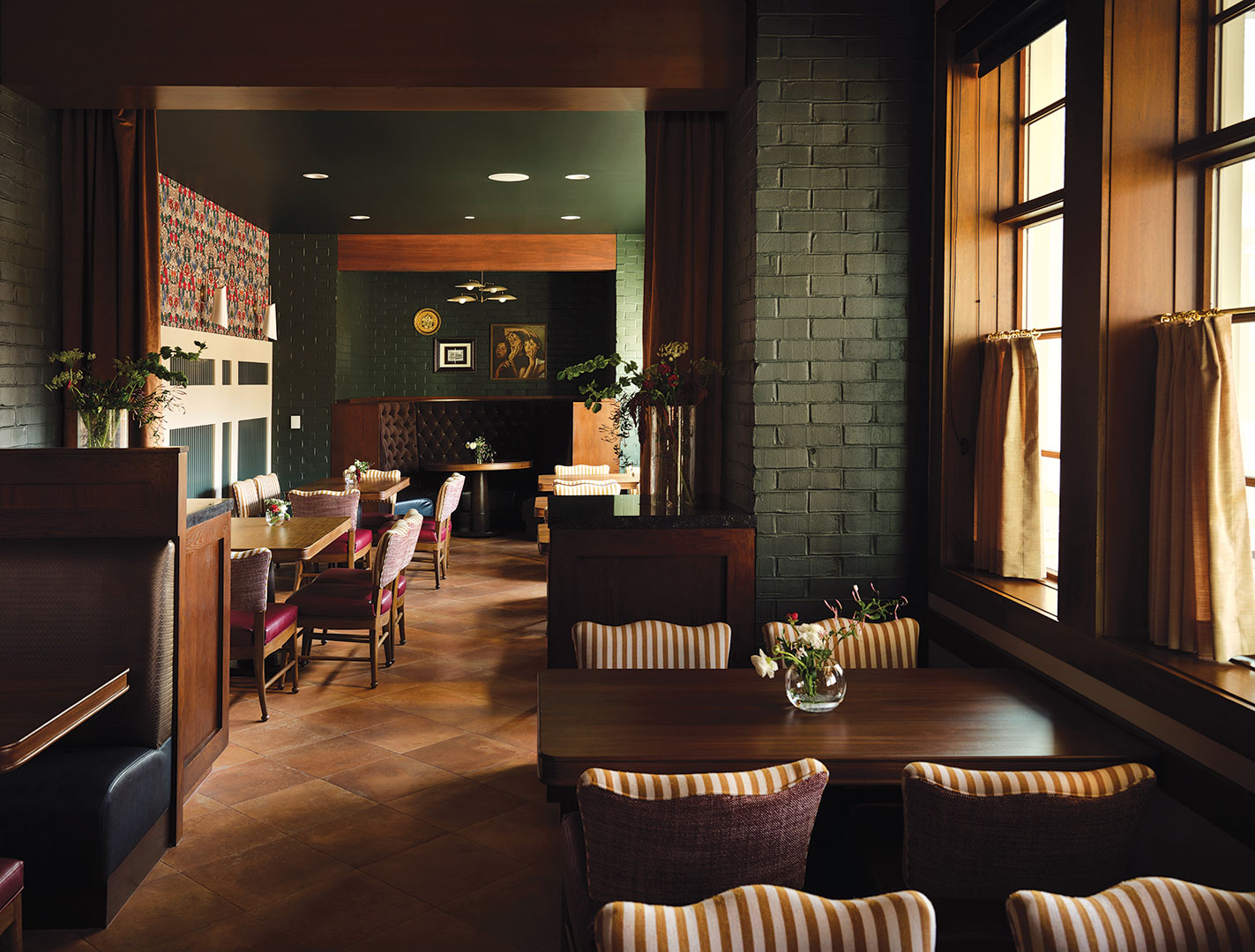 Guests at Belle & Grey are welcome in a host of gathering and dining spaces, including the main dining room, the Lake Street Dining Room, the Mezzanine Level with two porches, The Fireside Room and The Library.