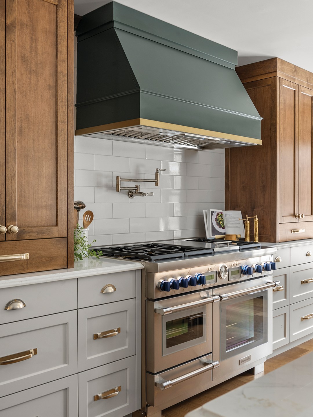 Some of the kitchen’s cabinets are anchored by horizontal drawers, which were designed for functional storage. One drawer houses silverware, and the other drawer keeps knives neatly organized and easily accessible.