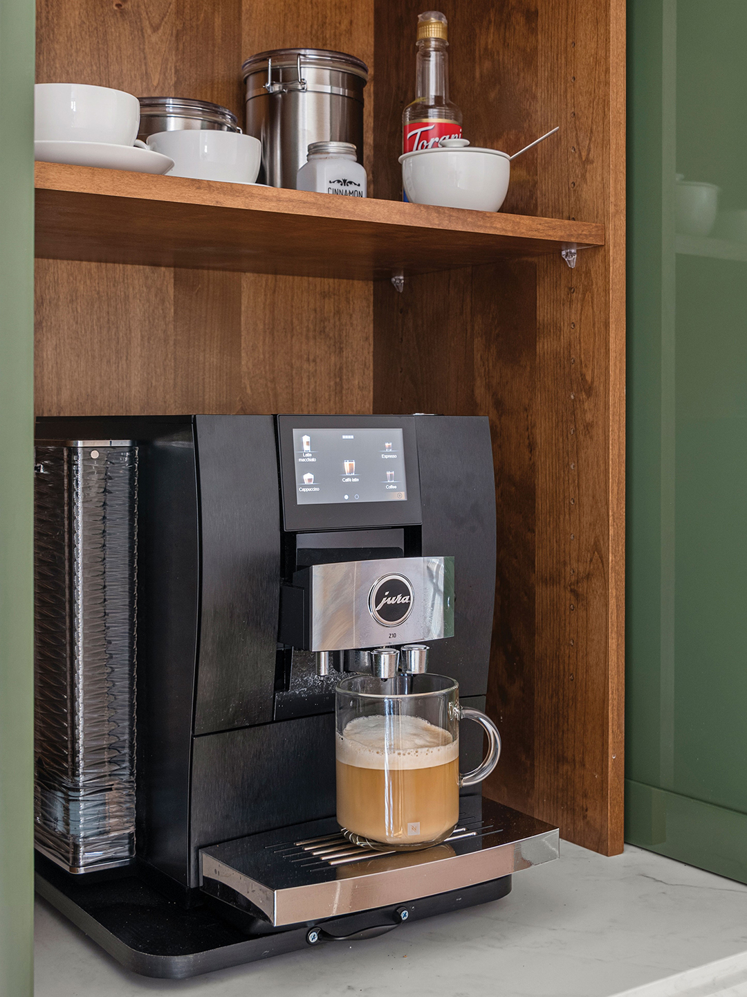 “The coffee station creates a small but meaningful ritual space within [our] home—a place to savor a morning cup before the day begins,” Rachel Gorman says. “When not in use, it disappears elegantly behind sliding doors, keeping the kitchen calm and uncluttered.”